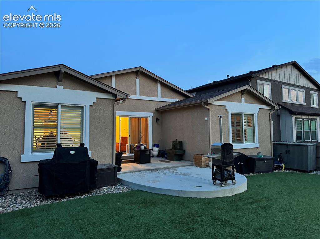 Image 28 of 29: Stucco exterior with white trim details