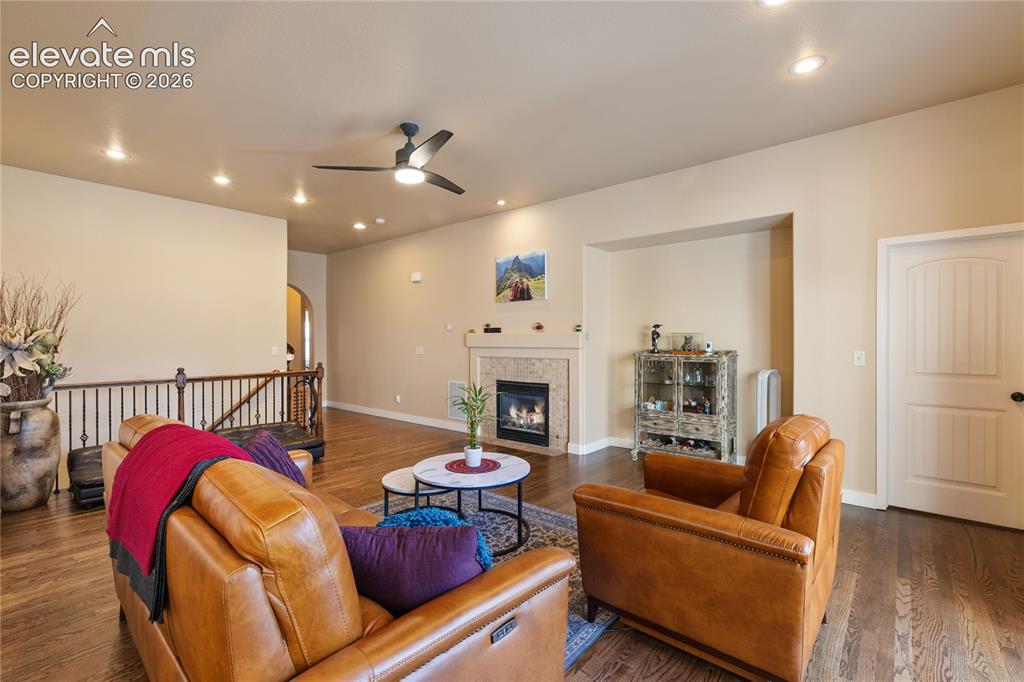Image 4 of 29: Wood-finish flooring, recessed lighting, and a ceiling fan