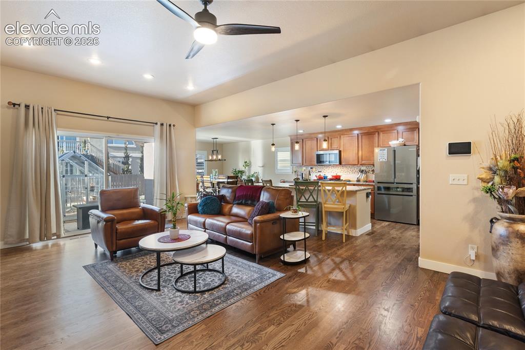 Image 9 of 29: Open concept living space featuring wood-finish flooring, recessed lighting