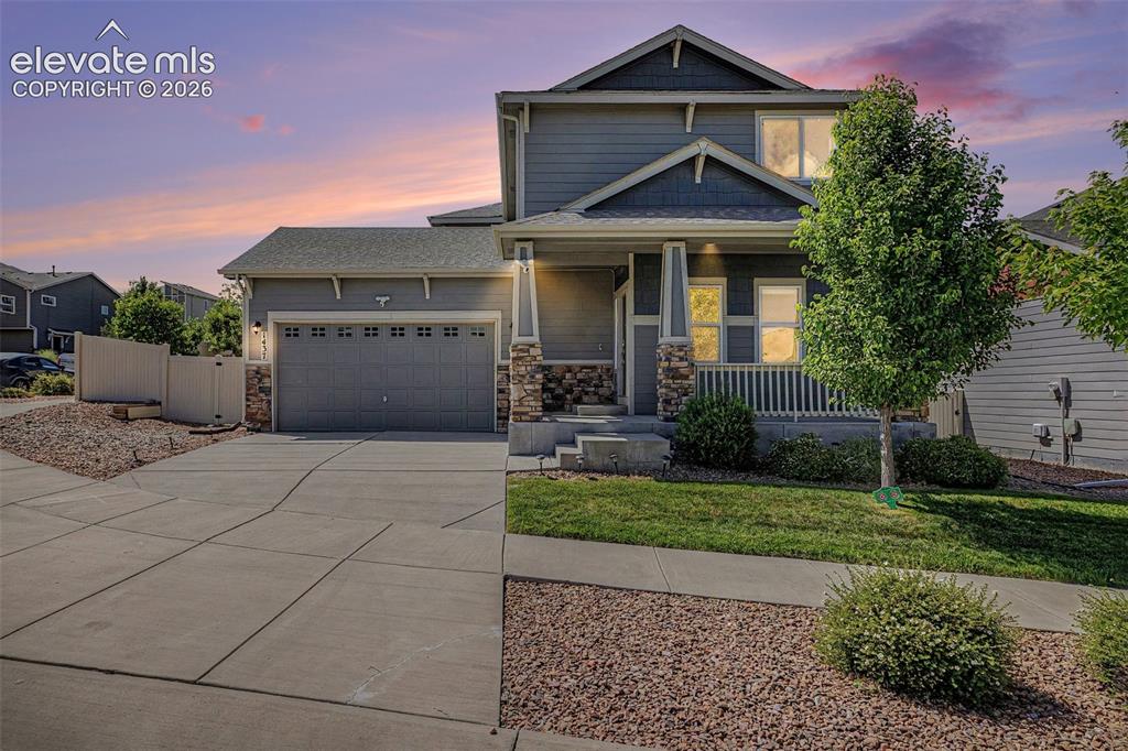 Image 1 of 39: Two-story residence featuring a covered front porch with white railings, st