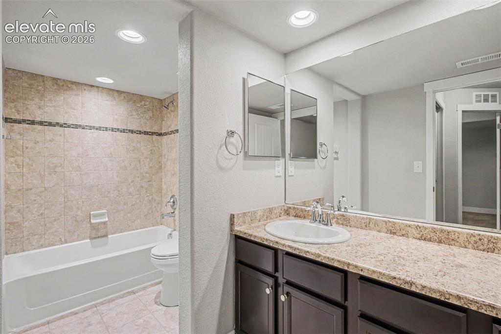 Image 33 of 39: Bathroom featuring a single vanity with a white oval sink, a light-colored