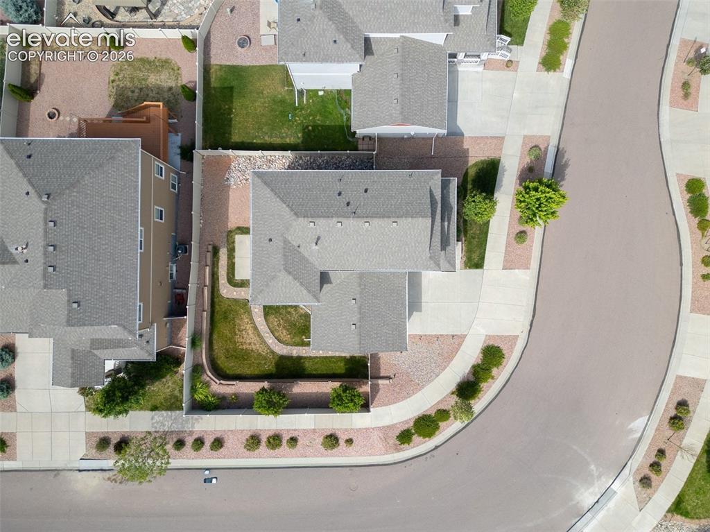 Image 37 of 39: Residential property with a gray shingled roof, featuring a front yard with