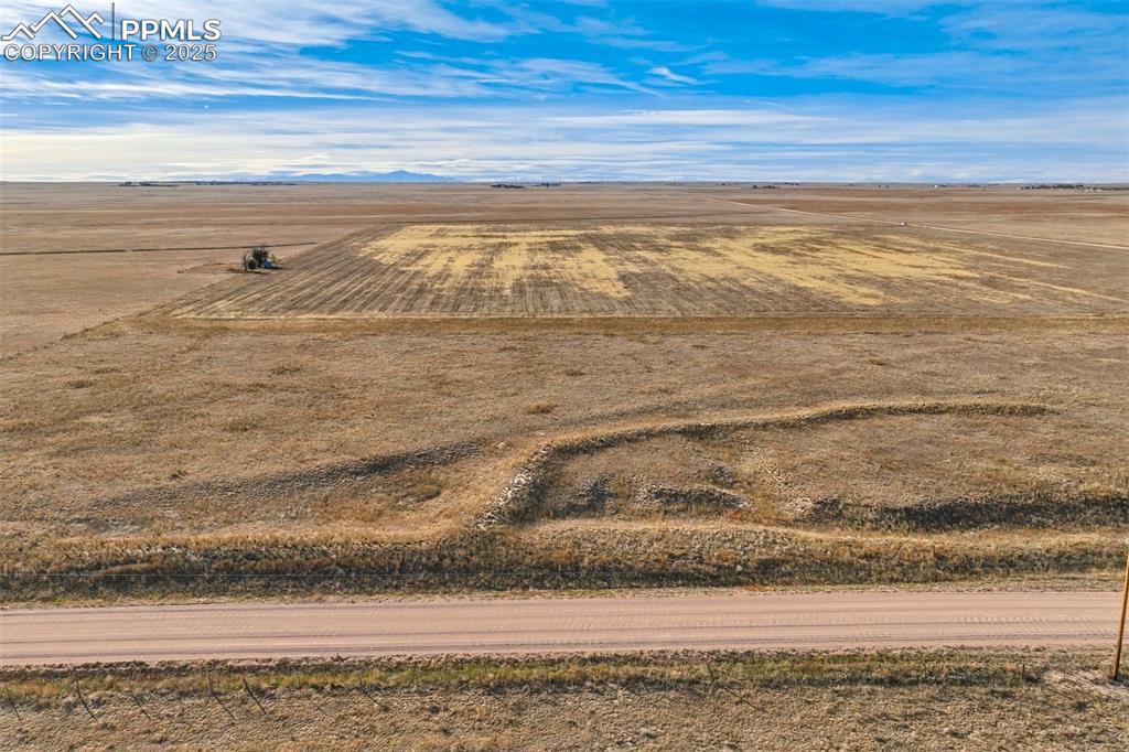 Image 10 of 25: Aerial view of sparsely populated area with a mountain backdrop