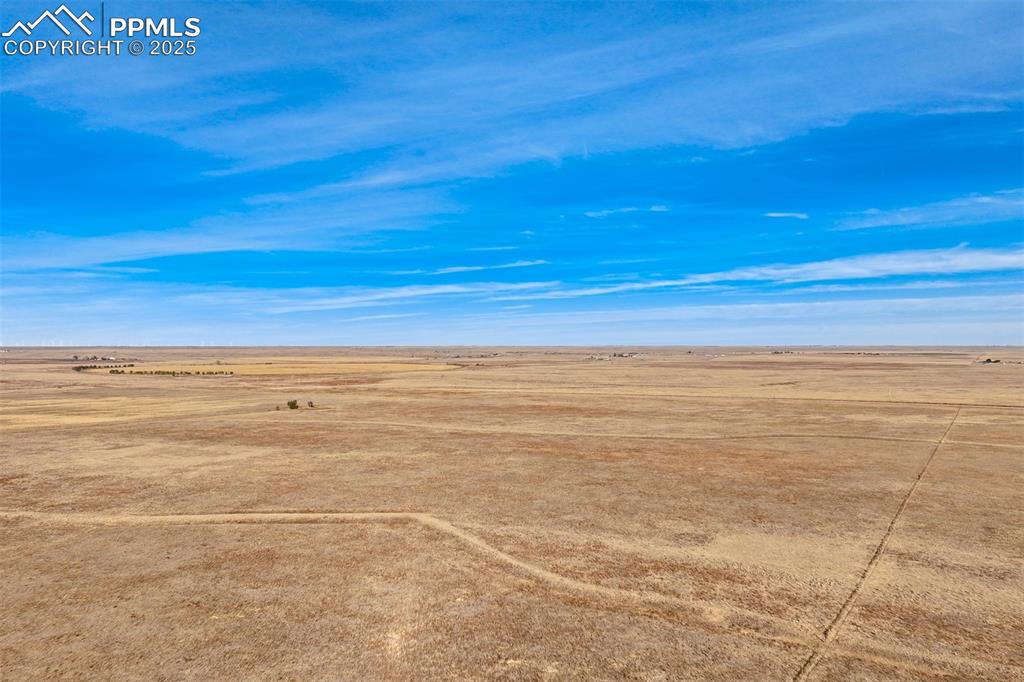 Image 13 of 25: Aerial view of sparsely populated area featuring a desert landscape