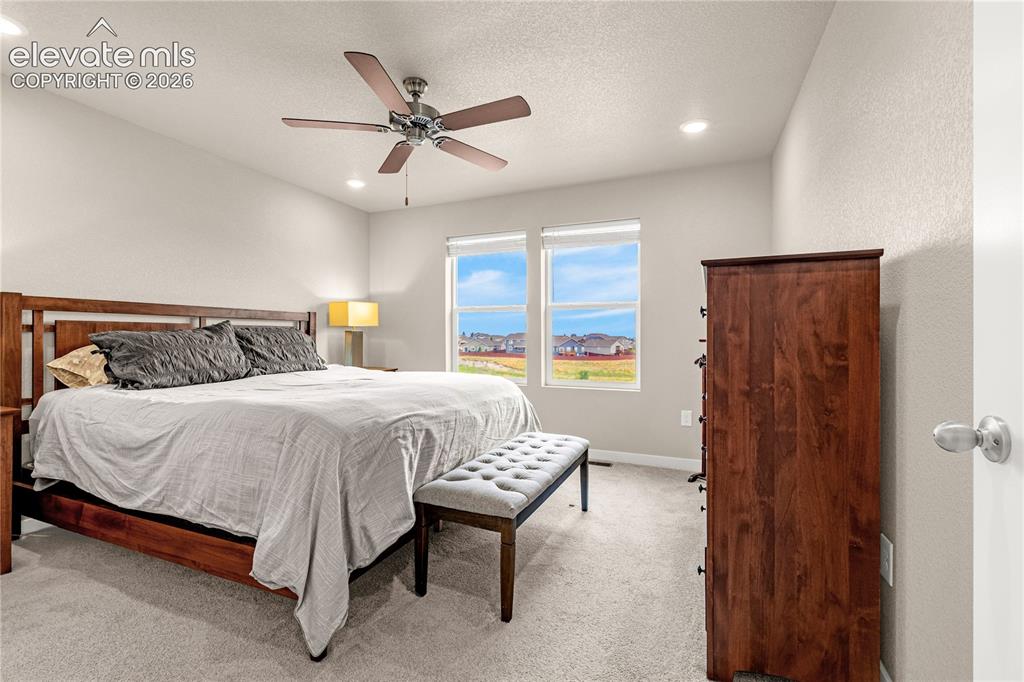 Image 10 of 30: Recessed lighting, ceiling fan, and light gray wall paint