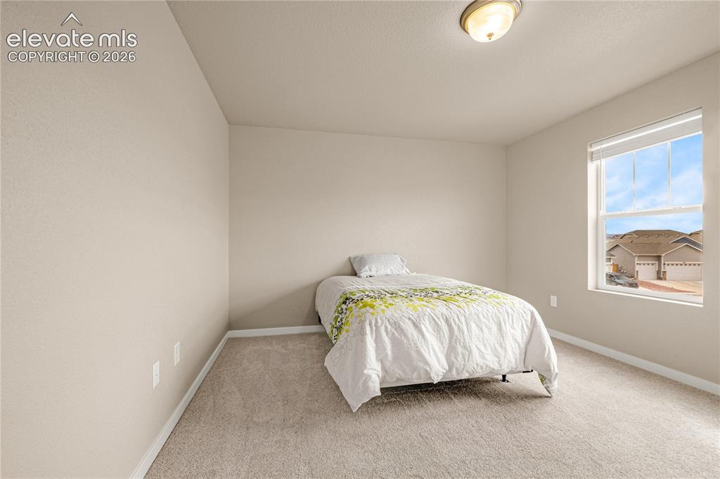 Image 17 of 30: Neutral-toned walls complement the light-colored carpeting