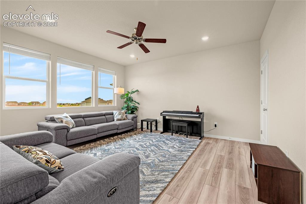 Image 6 of 30: High ceilings with recessed lighting, wood-finish flooring, a ceiling fan,