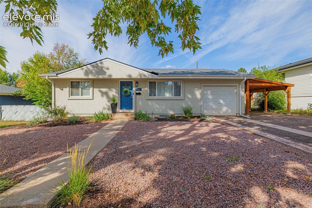 Image 25 of 27: Single-story stucco exterior with an attached garage, a carport, and a blue
