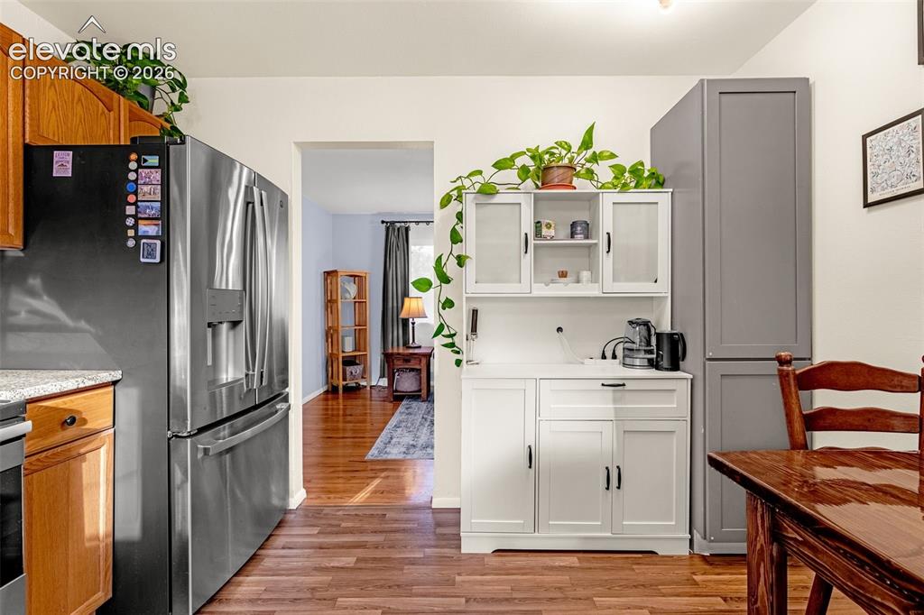 Image 3 of 27: Laminate wood-finish flooring kitchen, stainless steel French door refriger