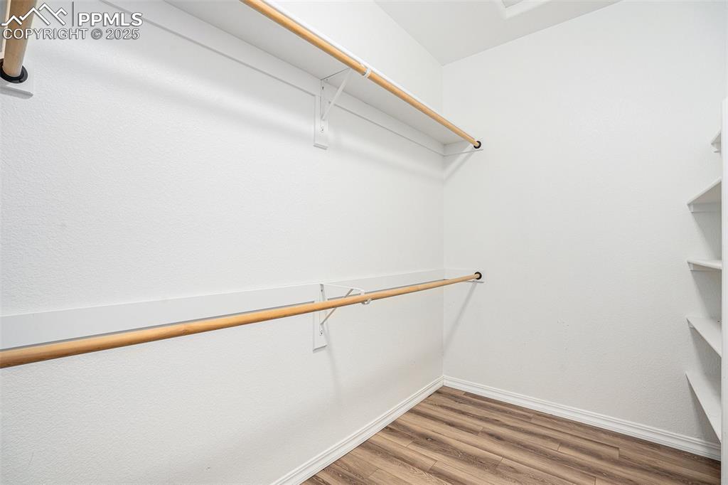 Image 13 of 24: Walk in closet featuring wood finished floors