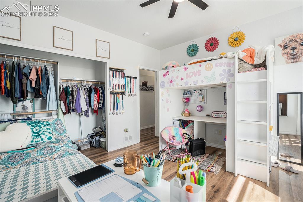 Image 16 of 24: Bedroom featuring light wood-style flooring, a closet, and a ceiling fan