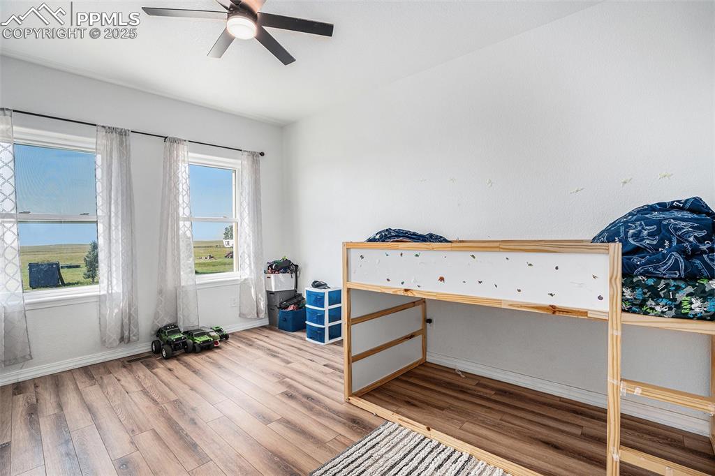 Image 18 of 24: Bedroom featuring wood finished floors and a ceiling fan