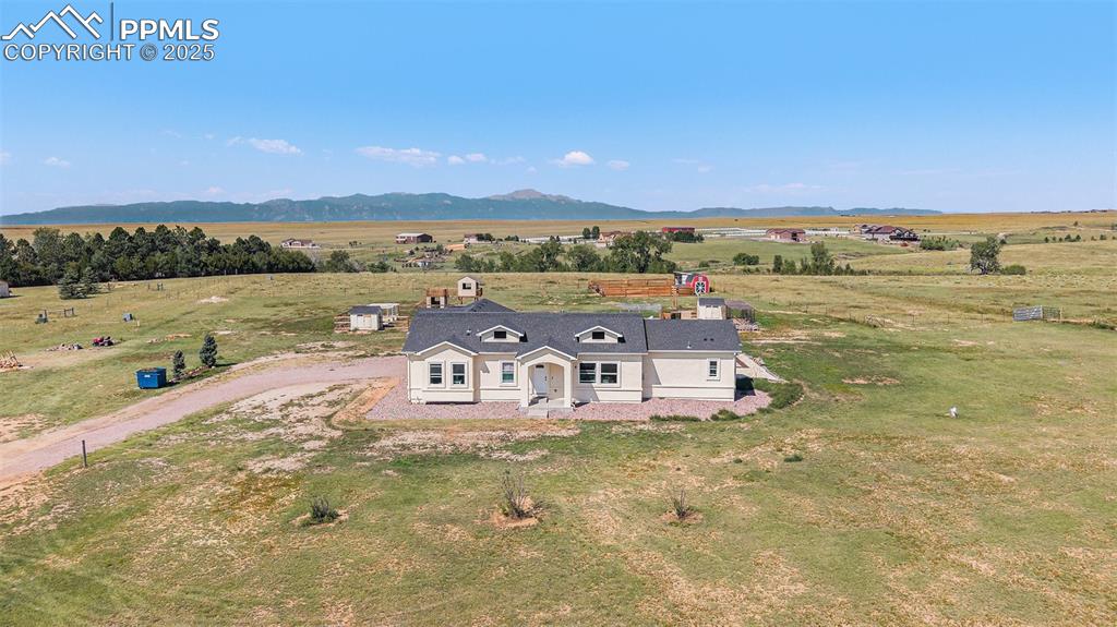 Image 2 of 24: View of rural area featuring a mountainous background