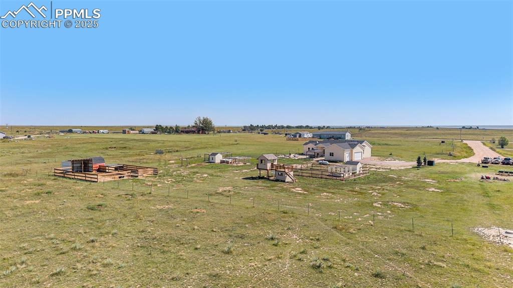 Image 23 of 24: Aerial view of sparsely populated area featuring agricultural land