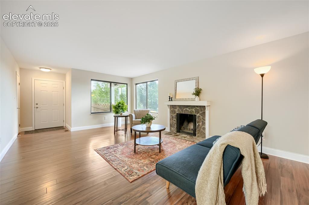 Image 3 of 10: New flooring and wood-burning fireplace