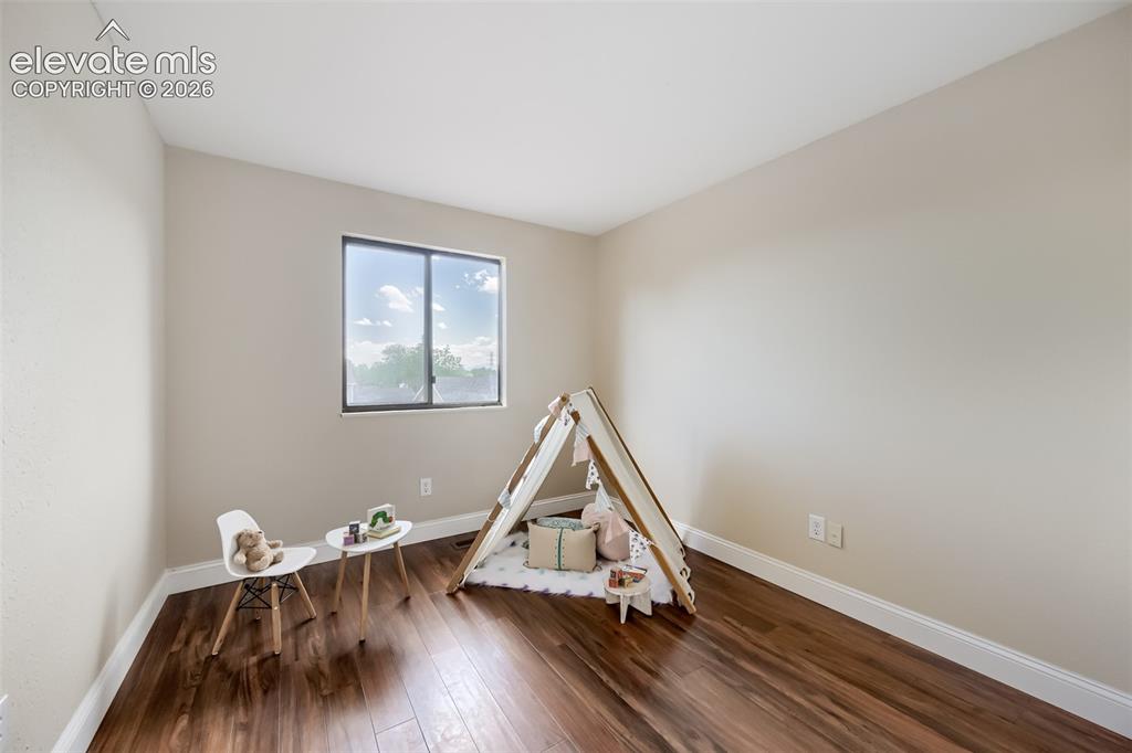 Image 7 of 10: Second bedroom with nice sized window and new floors