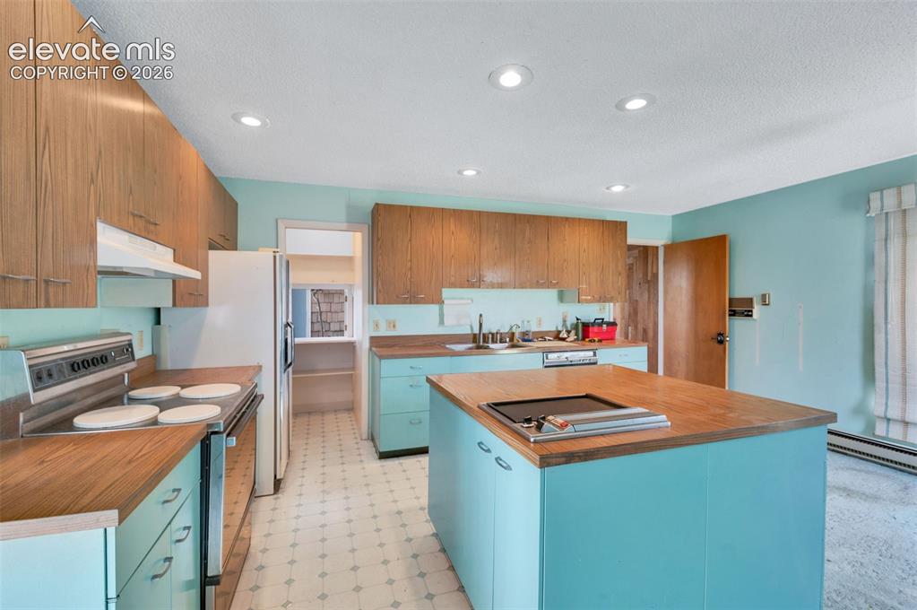 Image 14 of 50: The kitchen is elevated with classic St. Charles cabinetry. the 4