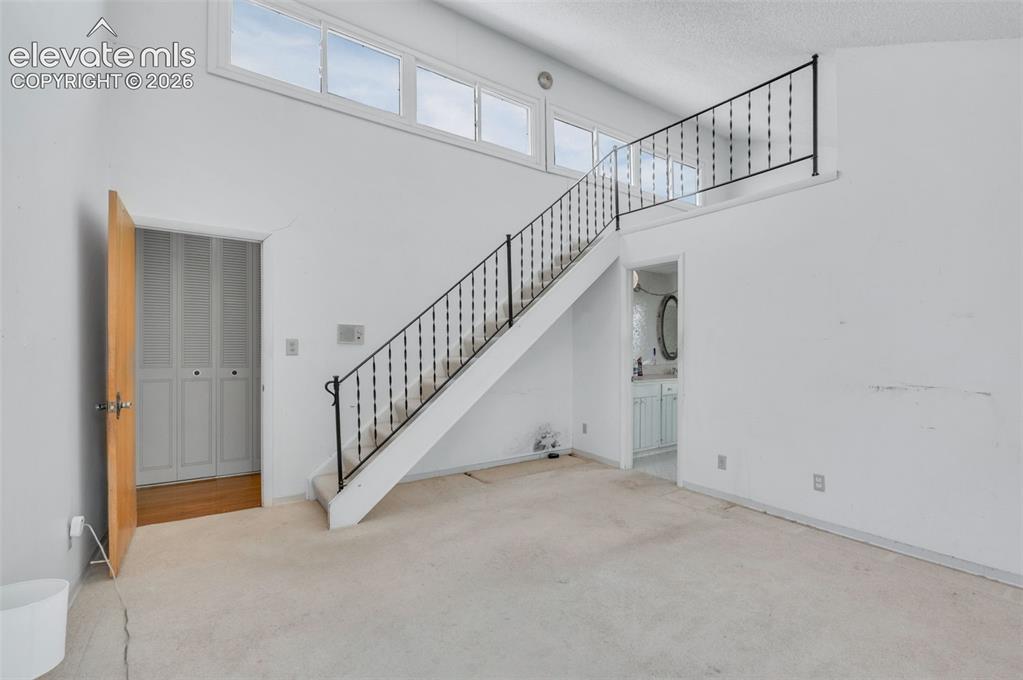 Image 20 of 50: Stairs lead to the loft study