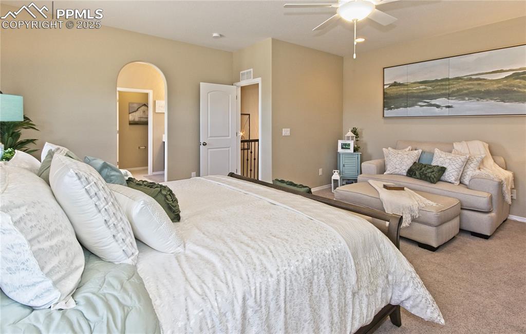 Image 23 of 30: Bedroom with carpet, a ceiling fan, and arched walkways