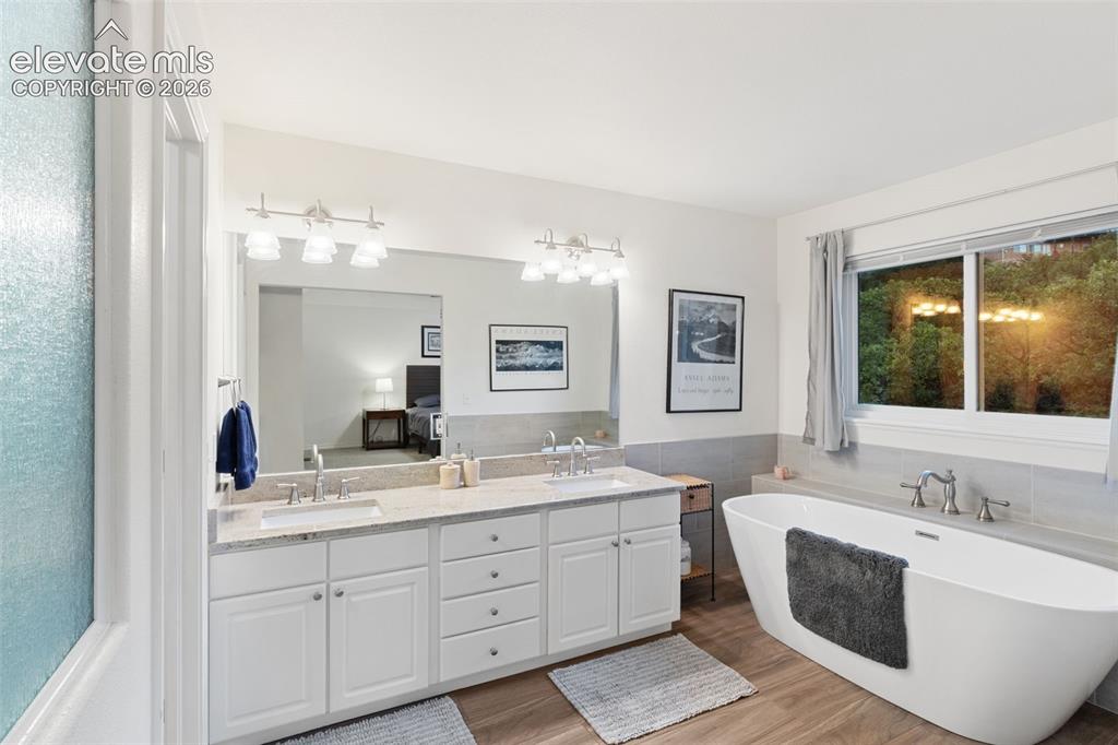 Image 19 of 47: Upper Level Main Bath, double vanity, standalone tub