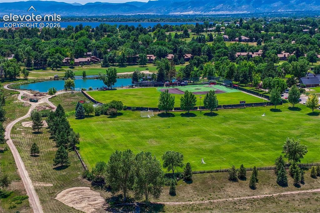 Image 2 of 35: Expansive green fields with manicured lawns and mature trees