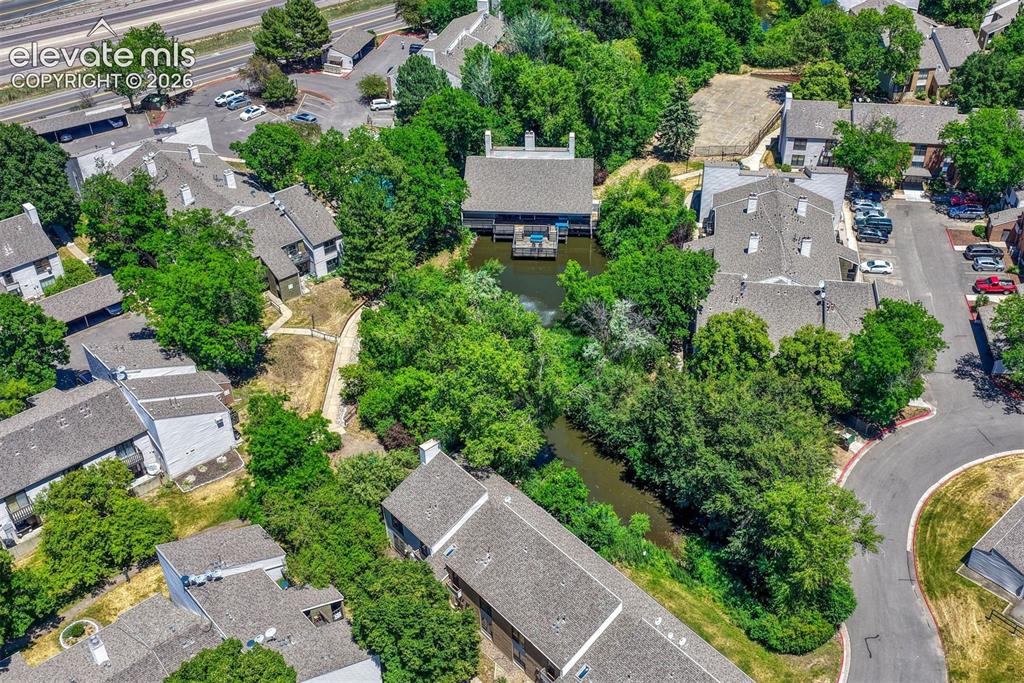 Image 22 of 35: Aerial perspective of a multi-building residential community featuring matu