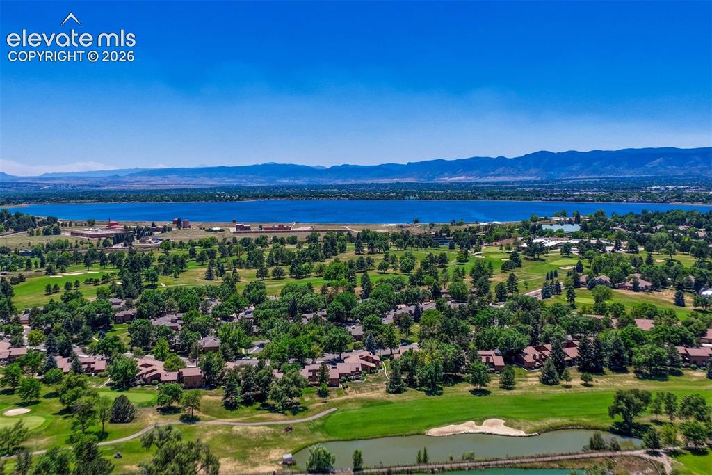 Image 28 of 35: Expansive golf course community featuring mature trees, multiple water feat
