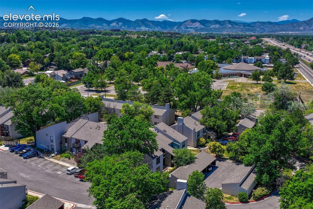 Image 3 of 35: Aerial perspective showcasing a residential community with mature trees, mu