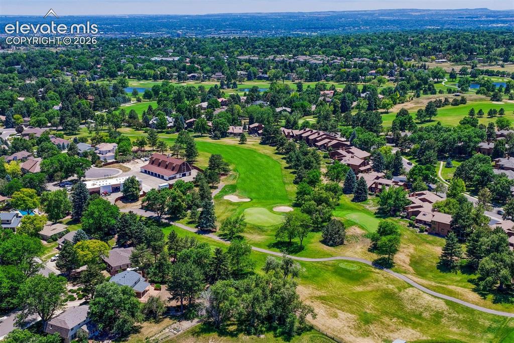 Image 30 of 35: Aerial overview revealing a verdant golf course surrounding residential pro