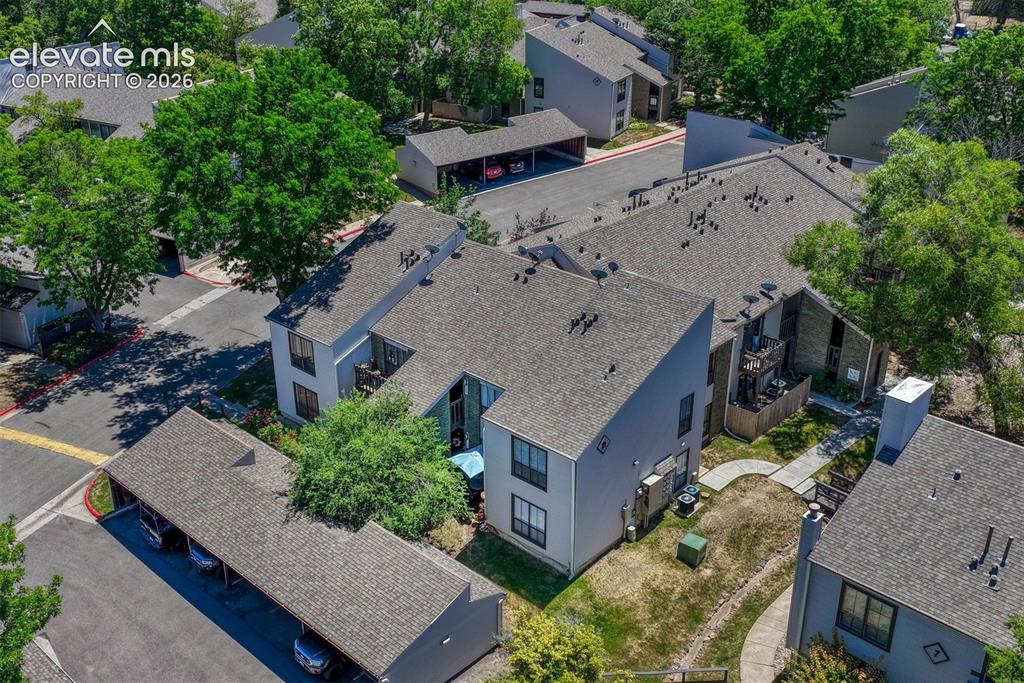Image 31 of 35: Aerial perspective of a multi-unit property featuring a neutral-toned exter