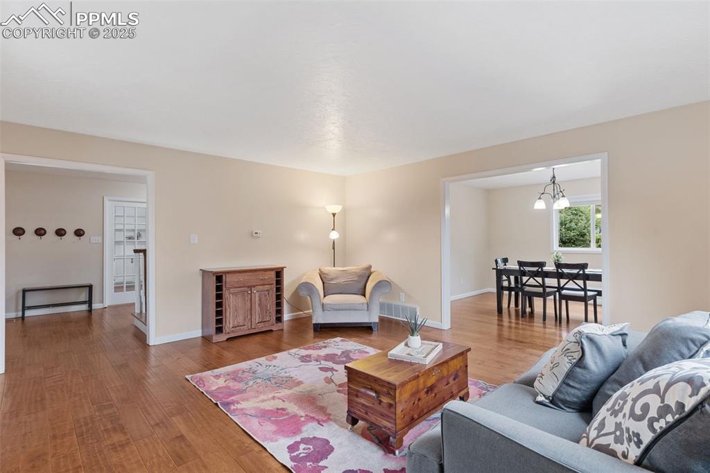 Image 11 of 45: Attractive living room with neutral colors and beautiful wood floor.