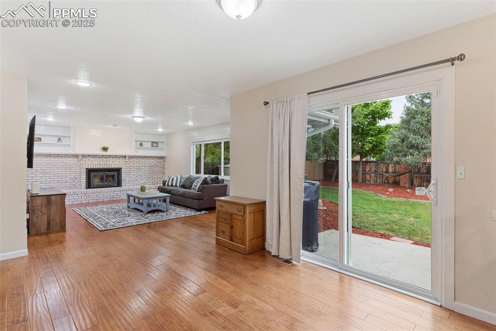 Image 15 of 45: Large family room off the kitchen with fireplace and a walk-out to the back