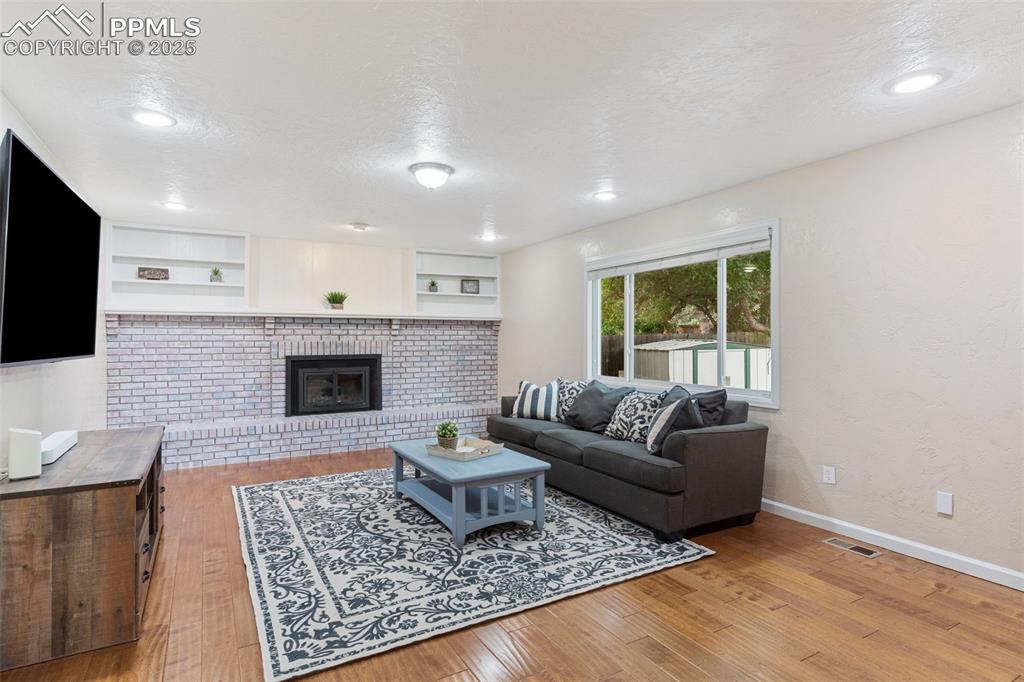 Image 16 of 45: Beautiful and inviting family room with fireplace.