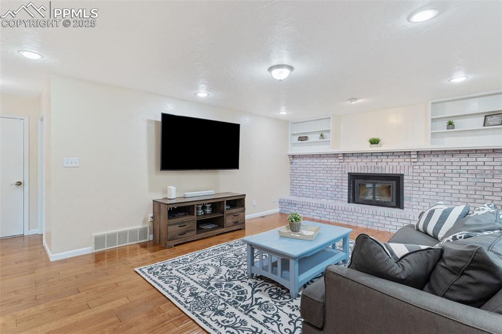 Image 17 of 45: Beautiful and inviting family room with fireplace.