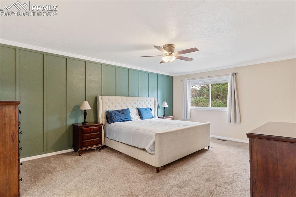 Image 22 of 45: Large mater bedroom with custom and stylish accent wall.