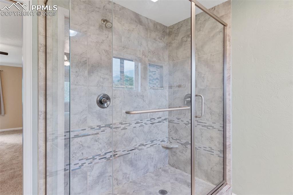 Image 25 of 45: Custom master bath with tile surround and dual showers.