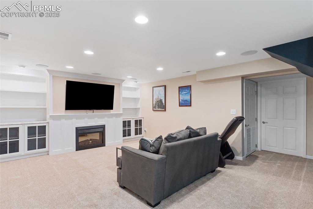 Image 34 of 45: Large, custom basement with built-ins, in-ceiling speakers for movie night!