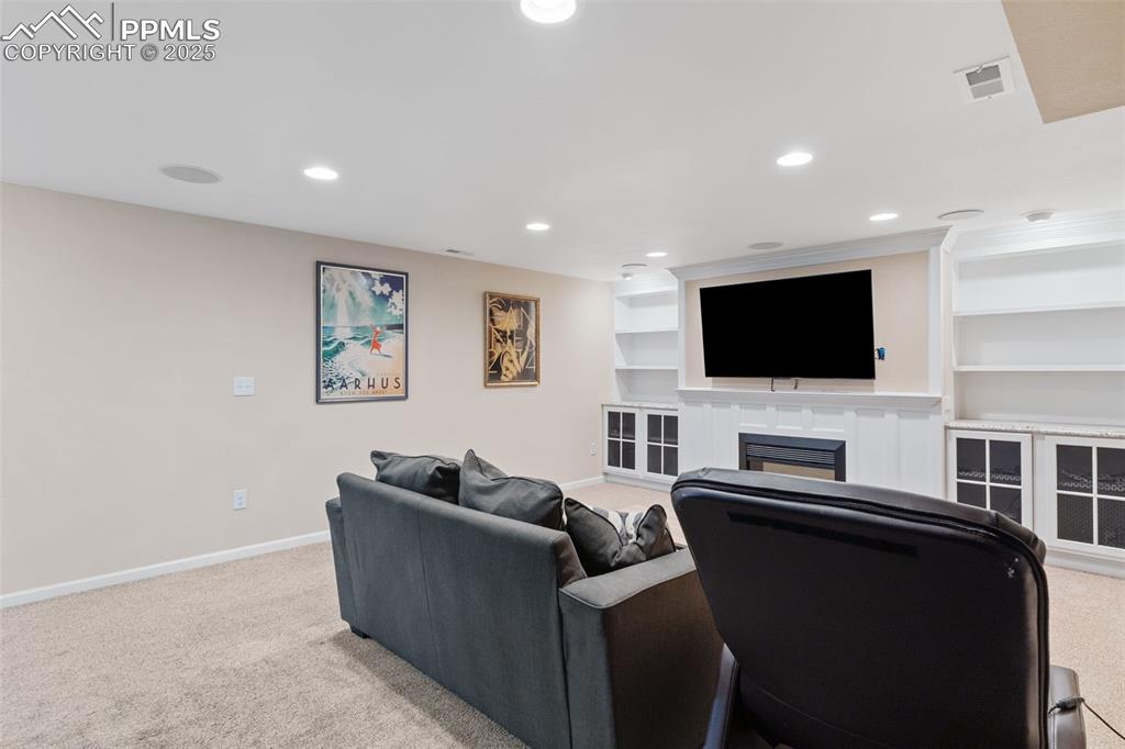 Image 36 of 45: Large, custom basement with built-ins, in-ceiling speakers for movie night!