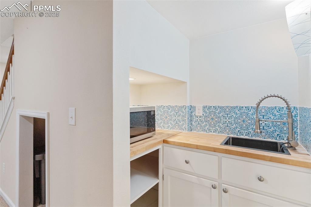 Image 38 of 45: Kitchenette in basement for guests or renter.