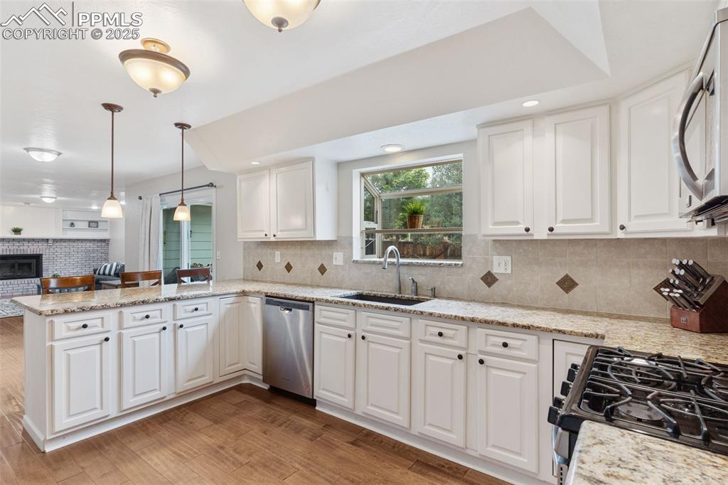 Image 7 of 45: Lovely, updated kitchen looks out onto backyard with garden window.