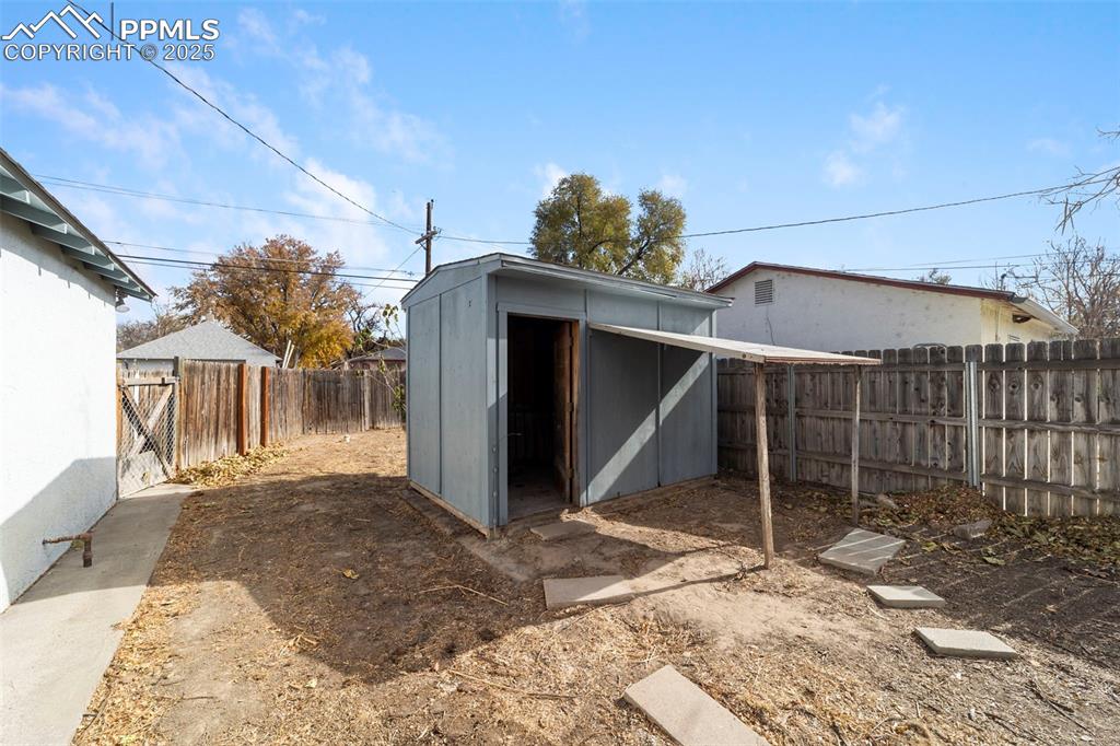 Image 35 of 41: View of shed featuring a fenced backyard