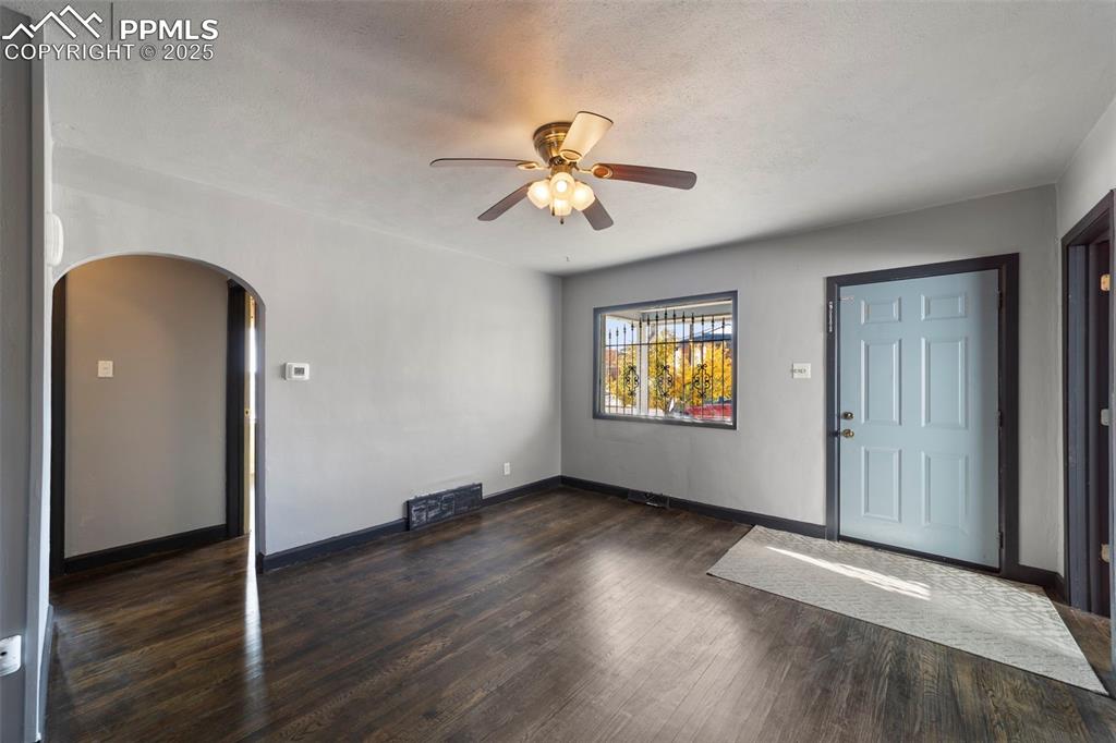 Image 6 of 41: Foyer entrance featuring dark wood-style floors, arched walkways, a ceiling