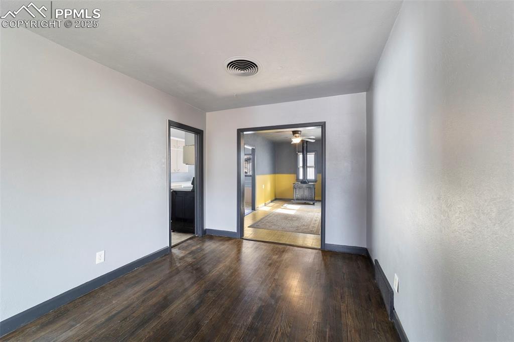 Image 8 of 41: Unfurnished room with dark wood-style floors and ceiling fan