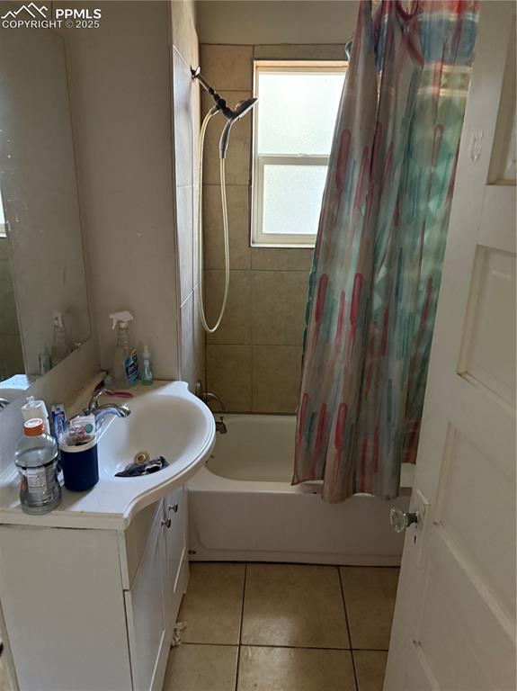 Image 10 of 11: Full bathroom with shower / bathtub combination with curtain, vanity, and l