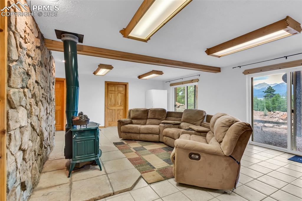 Image 28 of 43: Multiple walkouts from the den to the back yard. Enjoy the mountain views, 