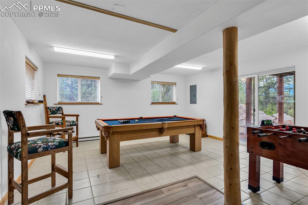 Image 33 of 43: Separate game room with walkout to backyard and mountain views