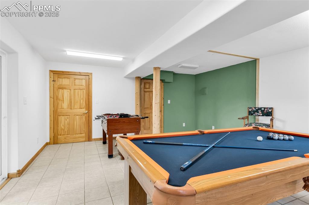 Image 34 of 43: Great space for a bar or kitchenette in the current gameroom. Would also ma