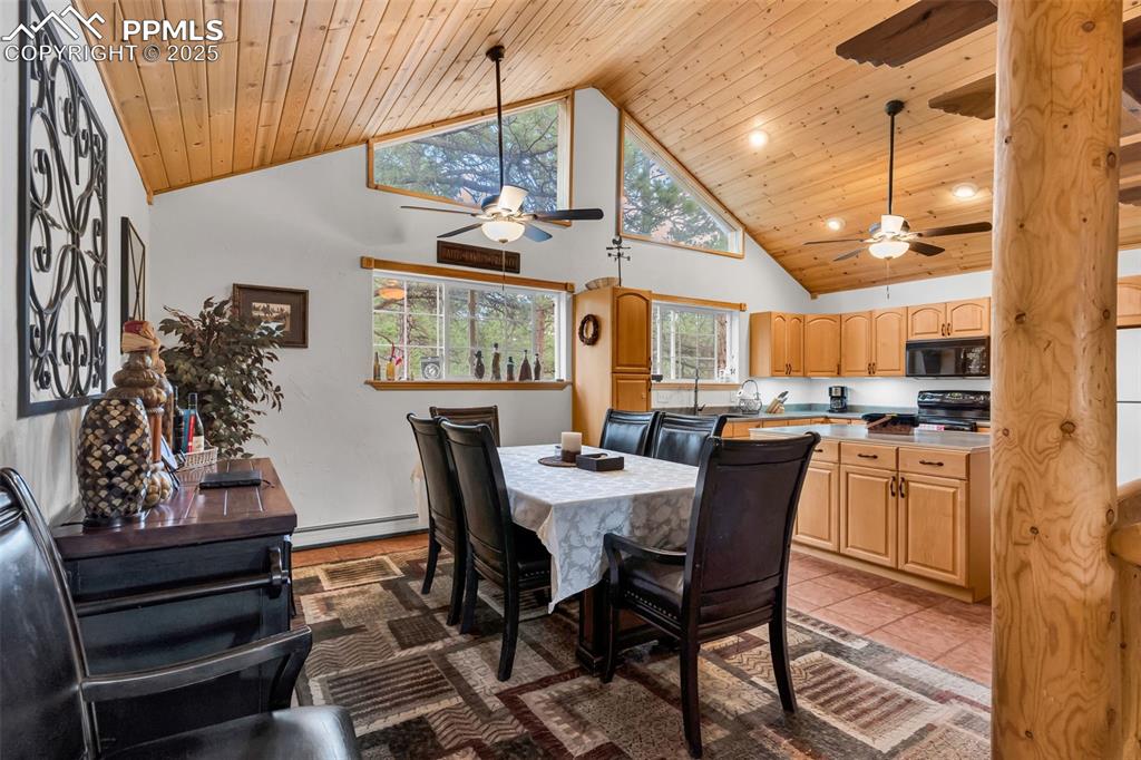 Image 8 of 43: Dining room and kitchen have vaulted ceilings with wood ceiling planks