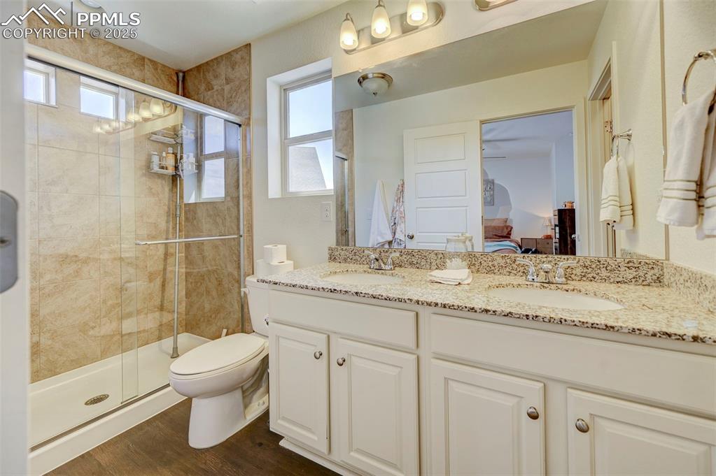 Image 18 of 32: Ensuite bathroom with connected bathroom, a sink, and a wealth of natural l