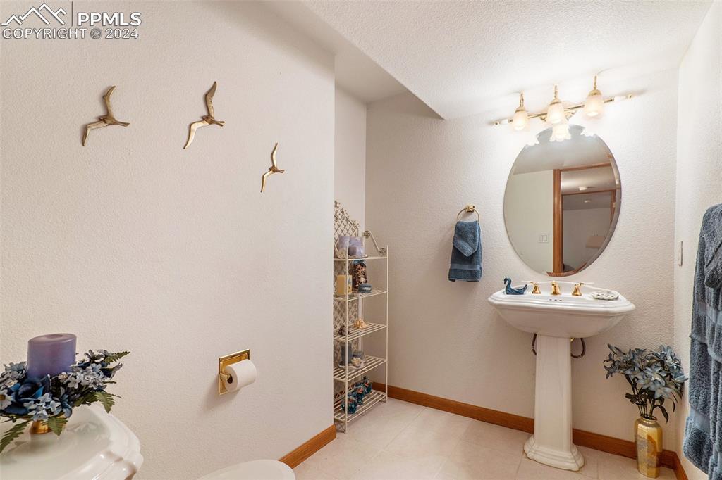 Image 38 of 50: Basement 1/2 Bathroom with tile floors